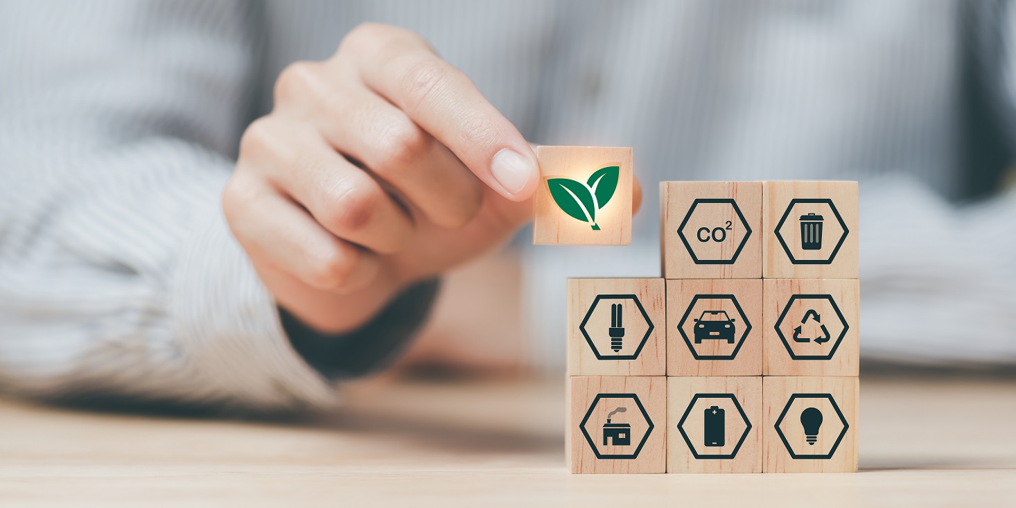 a person arranges cubes with images showing green energy innovation, environmentally friendly energy, technology, ecological sign
