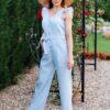 Woman in a garden dressed in linen blue jumpsuit