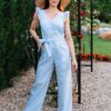 Woman in a garden dressed in linen blue jumpsuit