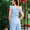 Woman in a garden dressed in linen blue jumpsuit