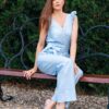 Woman in a garden dressed in linen blue jumpsuit
