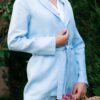 Woman dressed with blue linen jacket, white linen shirt and blue long pants