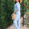 Woman dressed in blue linen shirt with long sleeves and blue long pants