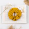 Linen yellow scrunchie on a book
