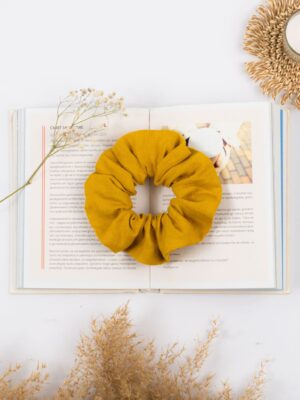 Linen yellow scrunchie on a book