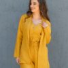 Woman dressed in yellow linen jacket, yellow linen shorts and yellow linen shirt