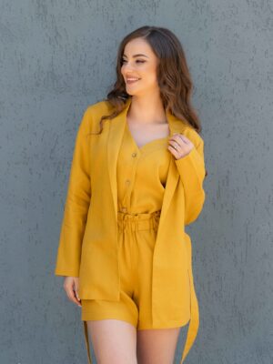 Woman dressed in yellow linen jacket, yellow linen shorts and yellow linen shirt
