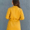 Woman dressed in yellow linen jacket, yellow linen shorts and yellow linen shirt