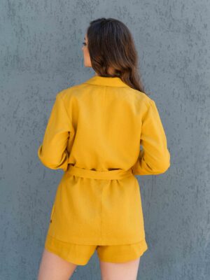 Woman dressed in yellow linen jacket, yellow linen shorts and yellow linen shirt