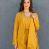 Woman dressed in yellow linen jacket, yellow linen shorts and yellow linen shirt