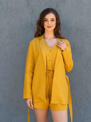 Woman dressed in yellow linen jacket, yellow linen shorts and yellow linen shirt