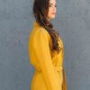 Woman dressed in yellow linen jacket, yellow linen shorts and yellow linen shirt