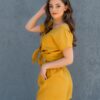 Woman dressed in yellow linen shorts and yellow linen shirt