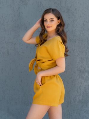 Woman dressed in yellow linen shorts and yellow linen shirt