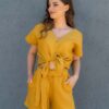 Woman dressed in yellow linen shorts and yellow linen shirt