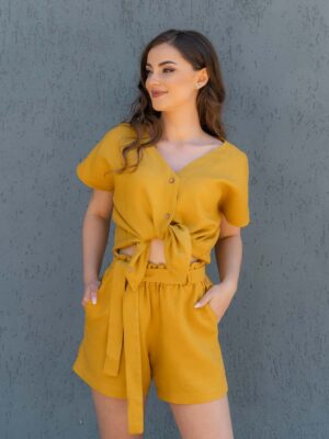 Woman dressed in yellow linen shorts and yellow linen shirt