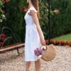 Woman dressed in white linen dress