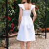 Woman dressed in white linen dress