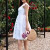 Woman dressed in white linen dress