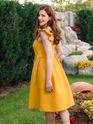 Woman in a garden, dressed in yellow linen dress