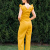 Woman in a garden dressed in linen yellow jumpsuit