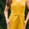 Woman in a garden dressed in linen yellow jumpsuit