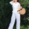 Woman dressed in white linen shirt with long sleeves and white long pants