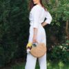 Woman dressed in white linen shirt with long sleeves and white long pants