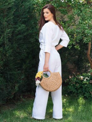 Woman dressed in white linen shirt with long sleeves and white long pants