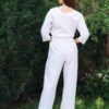Woman dressed in white linen shirt with long sleeves and white long pants