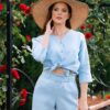 Woman dressed in blue linen shirt with long sleeves and blue long pants