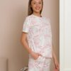 Woman wearing two-piece organic cotton summer pajamas with floral patterns