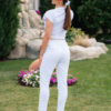 Woman wearing white organic cotton pants and white organic cotton t-shirt