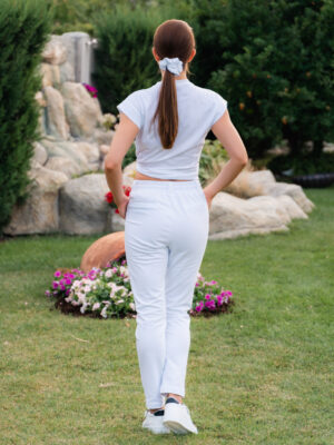 Woman wearing slim fit white organic cotton pants and white t-shirt