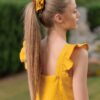 Woman waering yellow linen dres and yellow linen scrunchie on her hair
