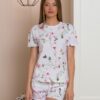Woman wearing two-piece organic cotton summer pajamas with floral patterns