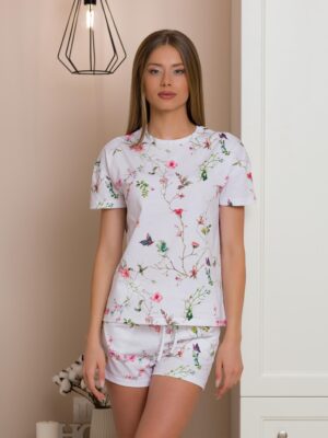 Woman wearing two-piece organic cotton summer pajamas with floral patterns