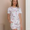 Woman wearing two-piece organic cotton summer pajamas with floral patterns
