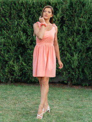 woman wearing a short peach dress
