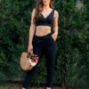Woman wearing women's slim fit black organic cotton pants