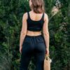 Woman wearing women's slim fit black organic cotton pants