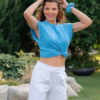 Woman wearing white organic cotton pants with side pockets and blue organic cotton t-shirt