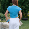 Woman wearing white organic cotton pants with side pockets and blue organic cotton t-shirt