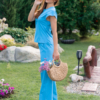 Woman wearing blue organic cotton pants with side pockets and blue organic cotton t-shirt