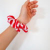 Organic cotton white and red stripes scrunchie on a hand