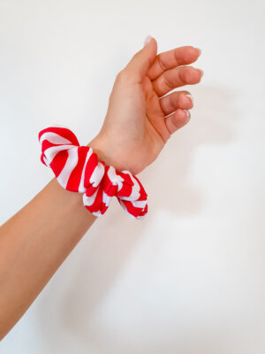 Organic cotton white and red stripes scrunchie on a hand