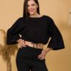 Woman with brown hair wearing black organic cotton wide sleeves blouse and black organic cotton long pants