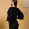 Woman with brown hair wearing black organic cotton wide sleeves blouse and black organic cotton long pants