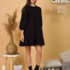 Woman with brown hair wearing black organic cotton dress with bouffant sleeves