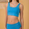 Woman wearing organic cotton blue nigh waisted bikini and blue top
